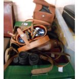 A box containing a quantity of vintage cameras including Kodak, Box Brownies, binoculars, etc.