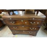 A 1.06m late Georgian mahogany bachelor's chest base with brushing slide and three long graduated