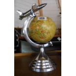 A modern Art Deco style globe with aeroplane to top