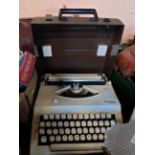 A vintage cased Imperial 2002 portable typewriter - sold with an old leather satchel style