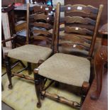 Two oak ladderback chairs with rush seats