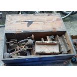 A wooden box containing assorted tools including planes, moulding planes, braces, etc.