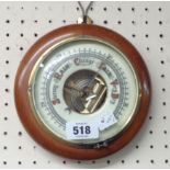 A small vintage stained wood cased wall barometer with visible aneroid works