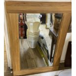 A pair of modern hardwood framed bevelled oblong wall mirrors - 61cm X 92cm