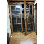 A 91cm early 20th Century oak bureau/bookcase with beaded glazed panel doors over a part fitted