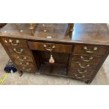 A 1.2m 19th Century mahogany desk with three frieze drawers, central cupboard and eight flanking