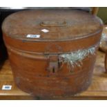 An old tin hat box containing a selection of Christmas tinsel and decorations