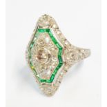 A marked PLAT Art Deco style curved panel ring with three central diamonds and paved emerald