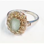 A marked 18ct white metal aquamarine and diamond ring