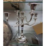 A modern silver plated four branch five light candelabrum with circular foot