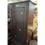 A late Victorian stained mixed wood pot cupboard enclosed by a panelled door