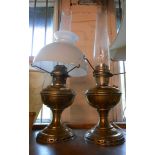 Two Aladdin table oil lamps, both with chimneys, one with white opaque shade
