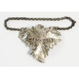 An antique silver vine pattern Sherry label with chain and pin attachment by Charles Rawlings and