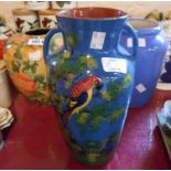 A Torquay pottery vase with embossed parrot decoration - sold with two other decorative vases -