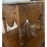 A Victorian mahogany commode with china liner and shaped apron, set on turned legs