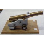 A brass and painted wood model cannon