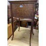 An early 20th Century oak sewing box with bi-folding top, set on slender square legs