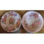 A pair of studio pottery wall plates decorated with hand painted dog roses - signed Terra 1991