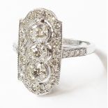 A marked PLAT ring with three open collar set central diamonds within a diamond encrusted border