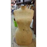 An old Stockman of Paris and London dressmaker's mannequin on metal stand with wooden finial