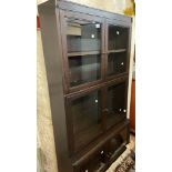 An 89cm old stained oak modular bookcase by Heal & Son, Ltd. with shelves enclosed by three pairs of