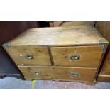 A 96cm antique pine campaign chest of two short and one long deep drawer with two original brass