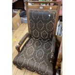 An Edwardian polished oak show frame panel back elbow chair with machine tapestry upholstery, set on