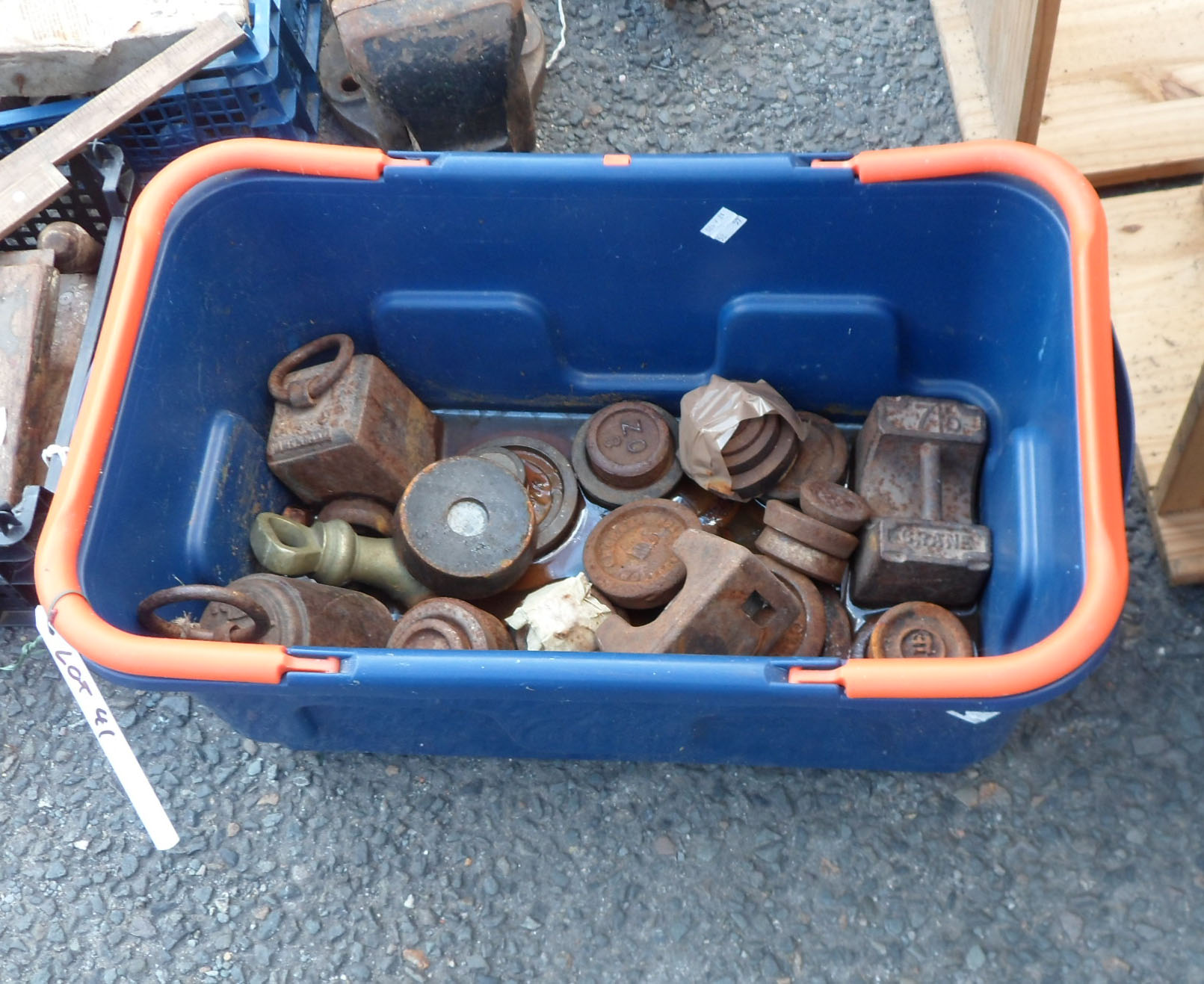 A crate containing assorted weights