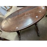 An antique mahogany oval topped coffee table, set on swept legs with brass caps and casters - a/f