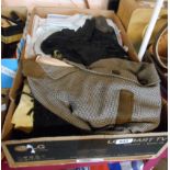 A box containing a quantity of textiles including damask and other tablecloths, tweed child's