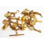 A 9ct. gold charm bracelet A 9ct. gold double kerb-link charm bracelet, set with numerous gold and
