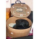 A vintage pressed card hatbox containing a small quantity of hats