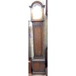 A vintage oak cased grandmother clock with silvered and brass arched dial, with spring driven