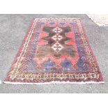 A 20th Century handmade Indian rug with central medallion and wide triple border - 2.15m X 1.55m