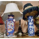 An antique Chinese blue and white prunus decorated vase with lamp conversion to top and four