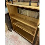 An 80cm modern pine three shelf open bookcase, set on plinth base