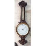 A late Victorian carved oak cased banjo barometer/thermometer, the dial marked for Ford of