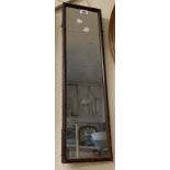 A stained wood framed narrow oblong wall mirror