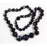 A faceted jet graduated bead necklace