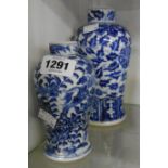 An antique Chinese porcelain jar decorated in blue - sold with a smaller similar - both with four