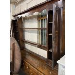 A 1.8m Georgian oak and mahogany strung Welsh two part dresser with three central open shelves and