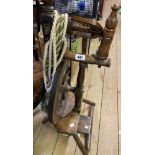 An antique stained wood spinning wheel