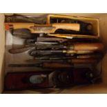 A box containing assorted woodworking tools including Stanley No.180 plane, chisels, etc.