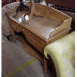 A 1.35m late Victorian waxed pine washstand with shaped splashback, five drawers and shaped