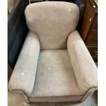 An early 20th Century club style armchair with mushroom coloured velour upholstery, set on front