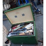 A painted box containing assorted painting and decorating tools including brushes, scrapers, etc.