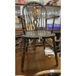 A set of six wheelback kitchen chairs with solid elm moulded seats, set on turned supports,