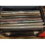 A record case containing a collection of Kiss LPs, 12" singles, picture discs and Japanese