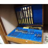 A vintage polished oak canteen containing a six place setting of silver plated cutlery