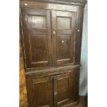 A 1.15m antique oak corner cabinet with remains of dentil cornice, canted sides and painted